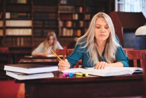 woman-working-desk-taking-notes