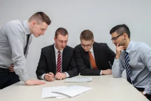 A group of people looking at the recent data on quality customer reference