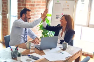 Colleagues doing a high five after a successful work day